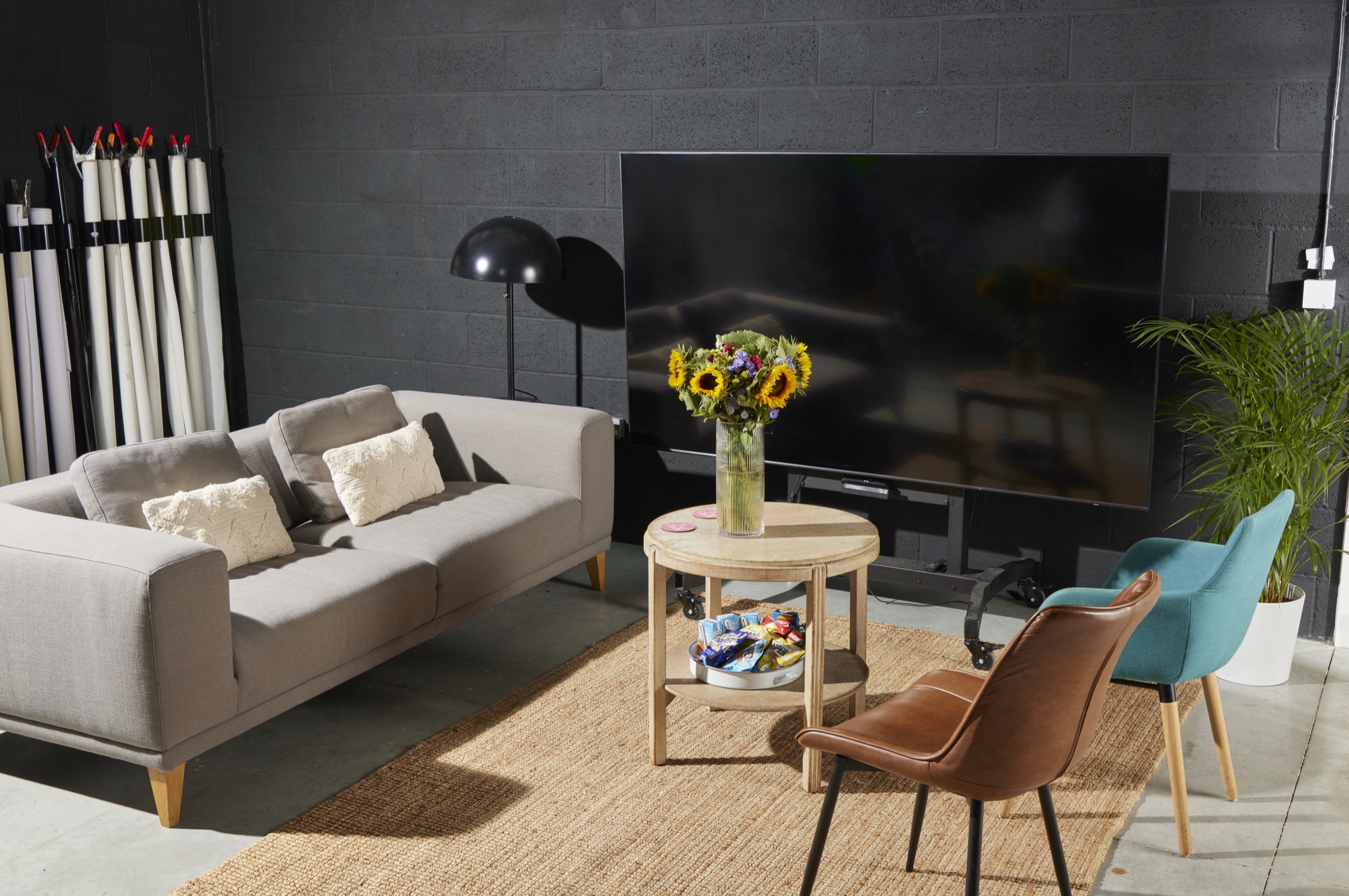 The client lounge: sofa, armchairs, viewing screen and refreshments