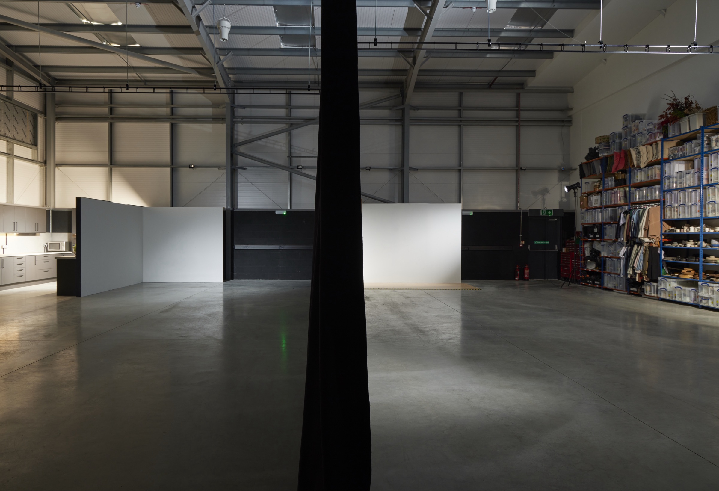 The full-height dividing curtain drawn across the centre of the studio